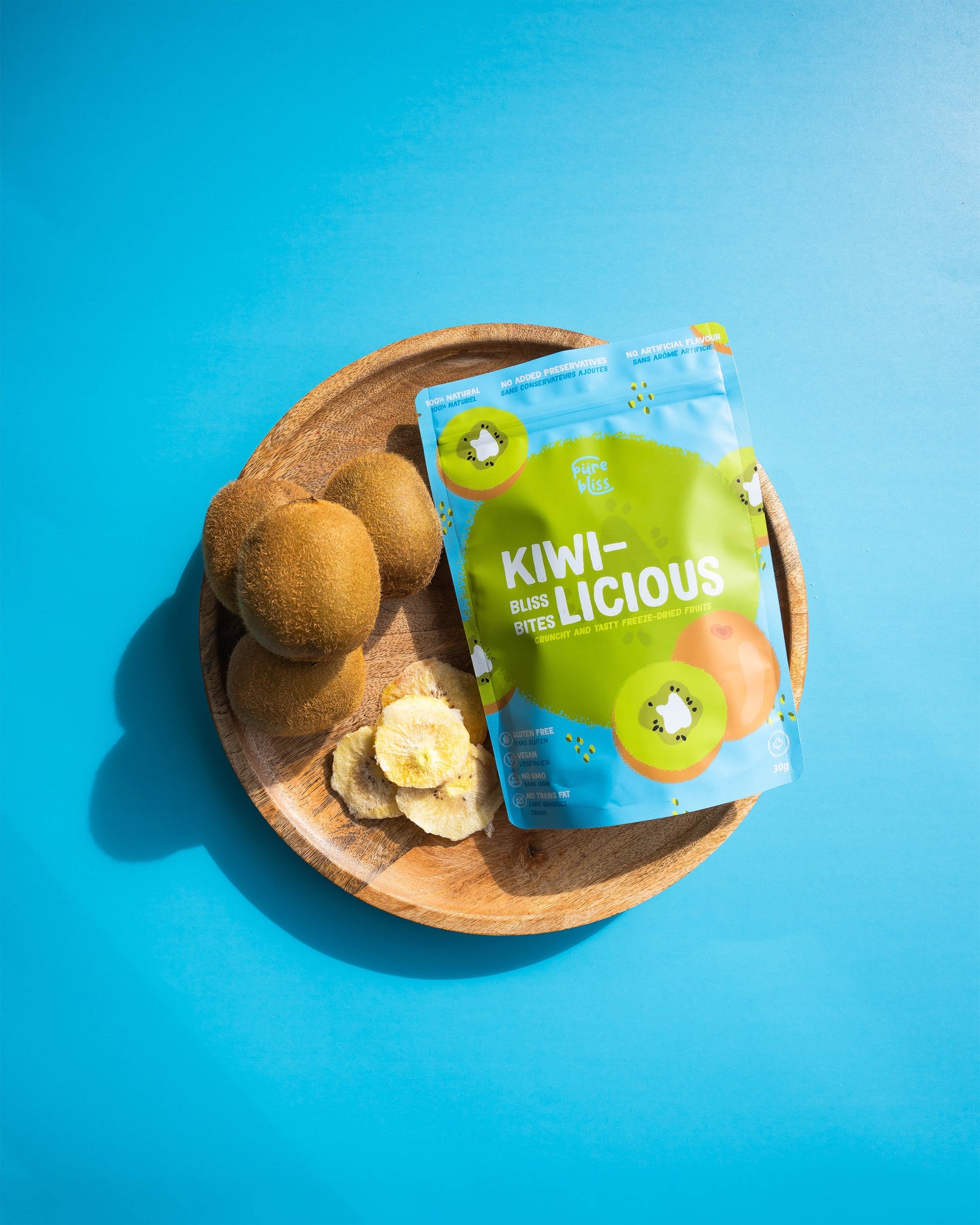 Kiwi-licious snack package with kiwis on a wooden plate against a blue background