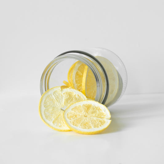 Freeze dried lemon slices in a glass jar on a white background